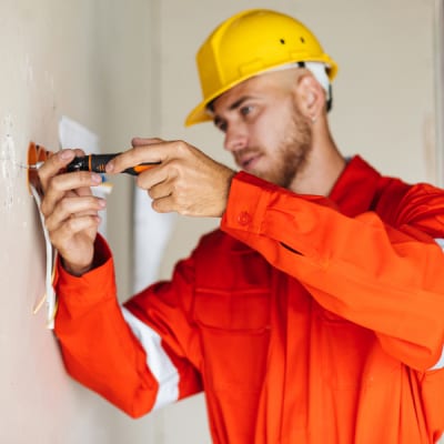 young-builder-in-orange-work-clothes-and-yellow-ha-2021-08-26-18-52-37-utc.jpg
